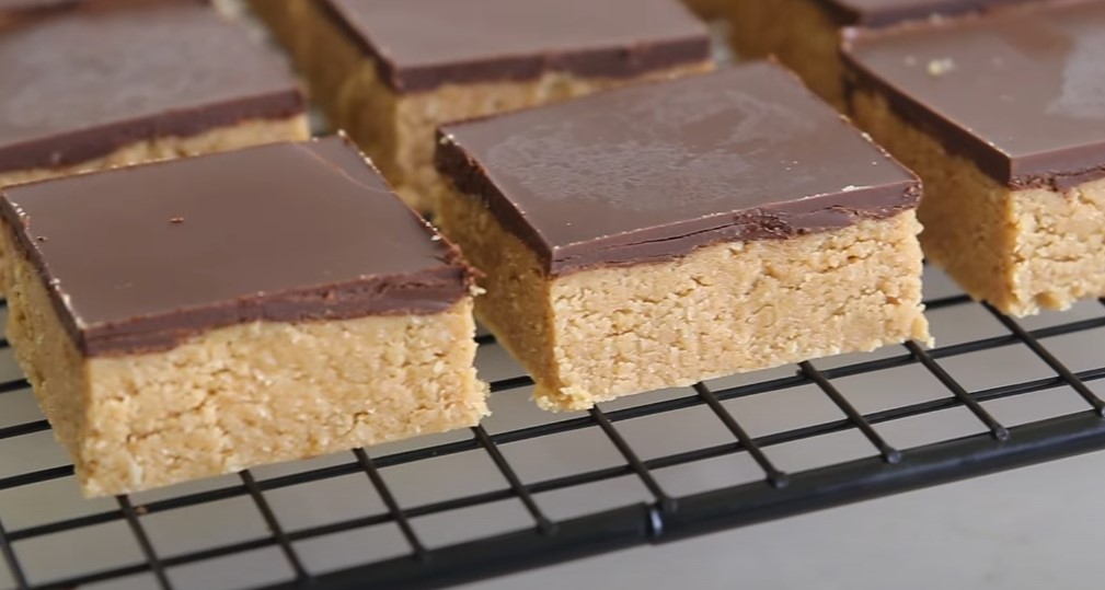 Close up photo of peanut butter bars covered in chocolate